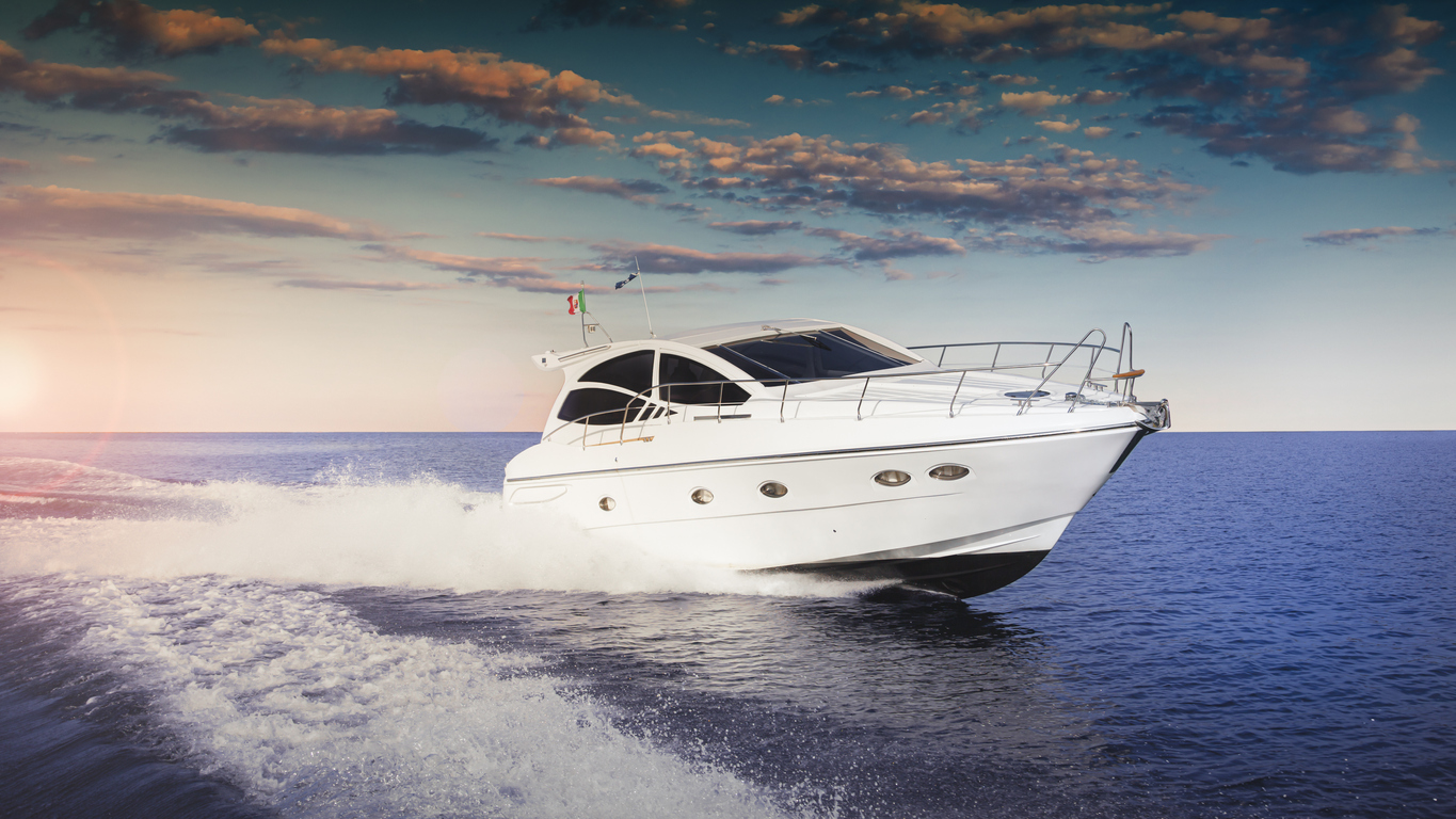 Luxurious motor boat sailing the sea at sunset