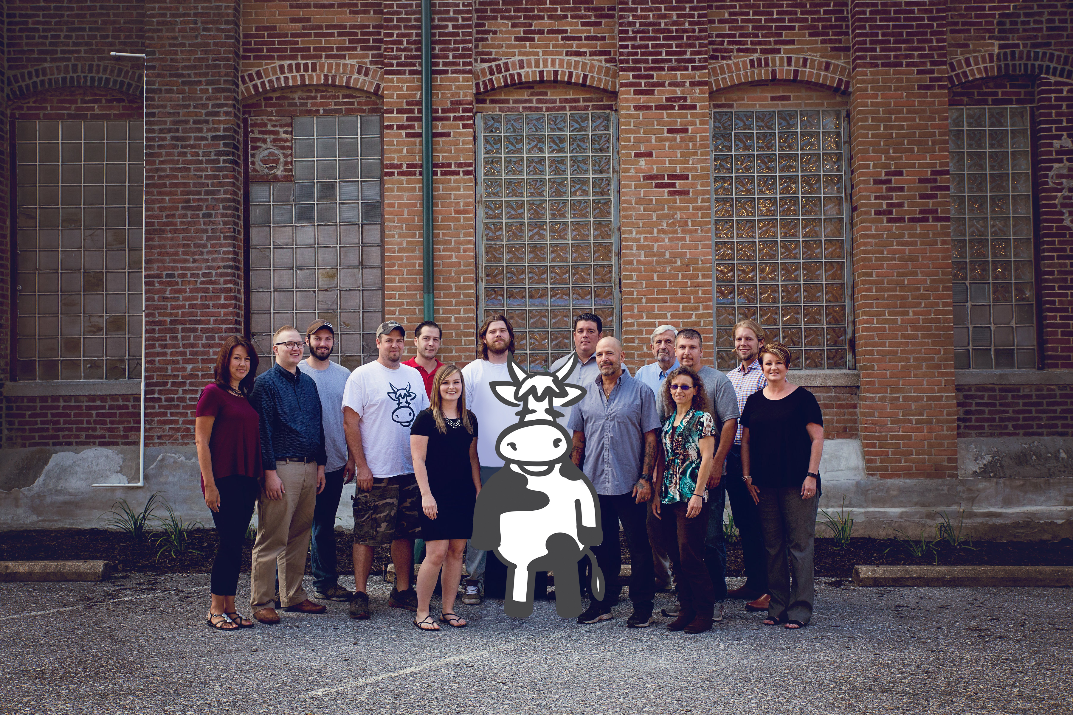 team photo of the staff with cow at American Micro Industries.